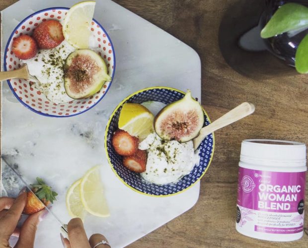 Our wholefood probiotic next to two delicious bowls of fresh fruit and yoghurt.